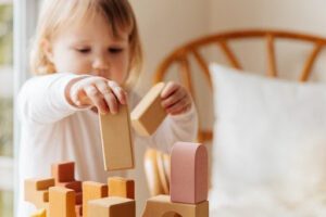 Young child playing with building blocks